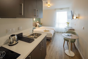 Premium bedding, desk, laptop workspace, blackout drapes