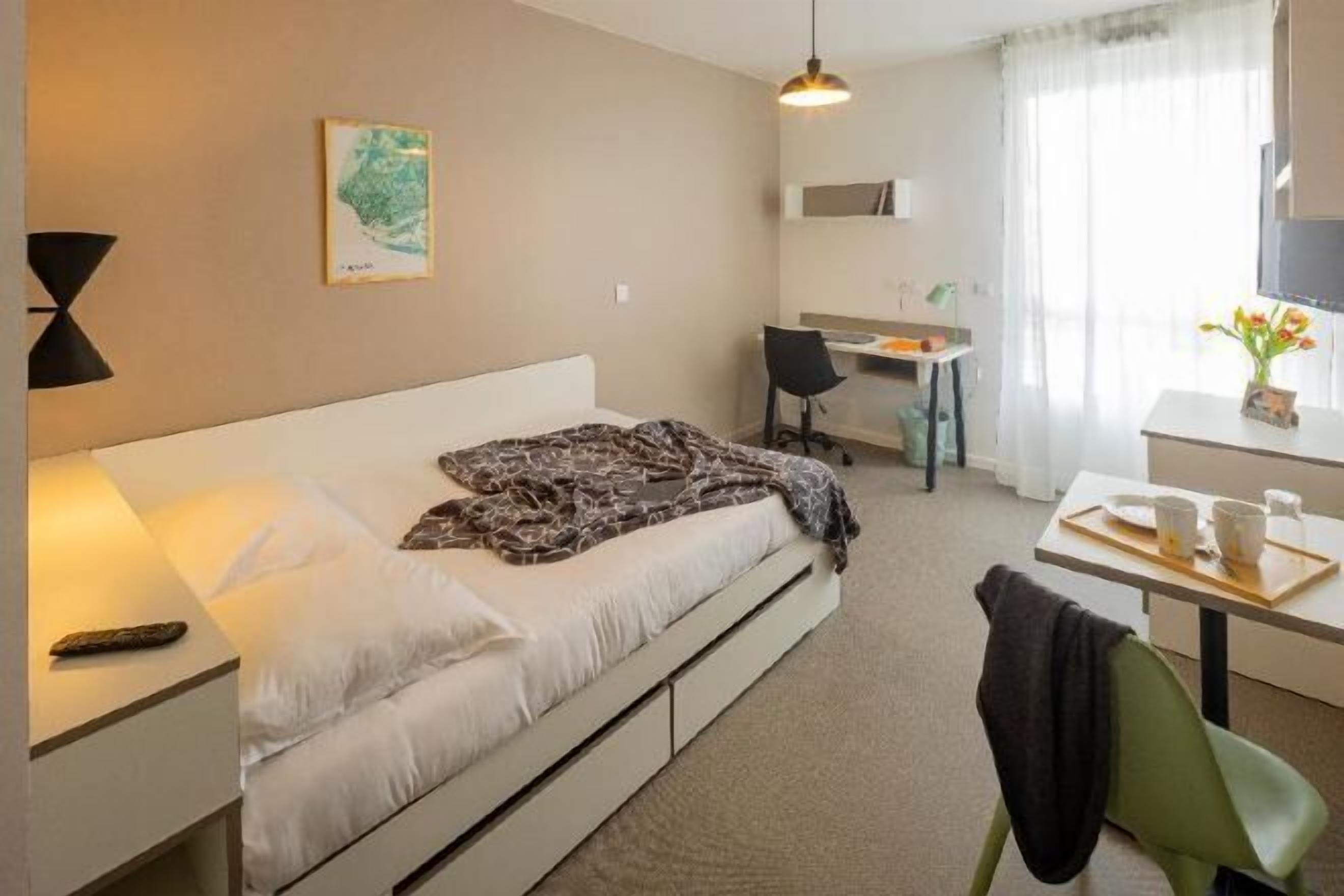 Premium bedding, desk, laptop workspace, blackout drapes