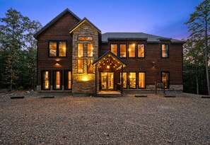 A two-story lodge with a stone entrance and multiple windows.