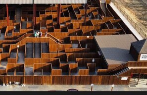 A large wooden maze structure with a covered roof, surrounded by a dirt path and greenery. - Lone Star Lodge Cabin in Broken Bow (Broken Bow)