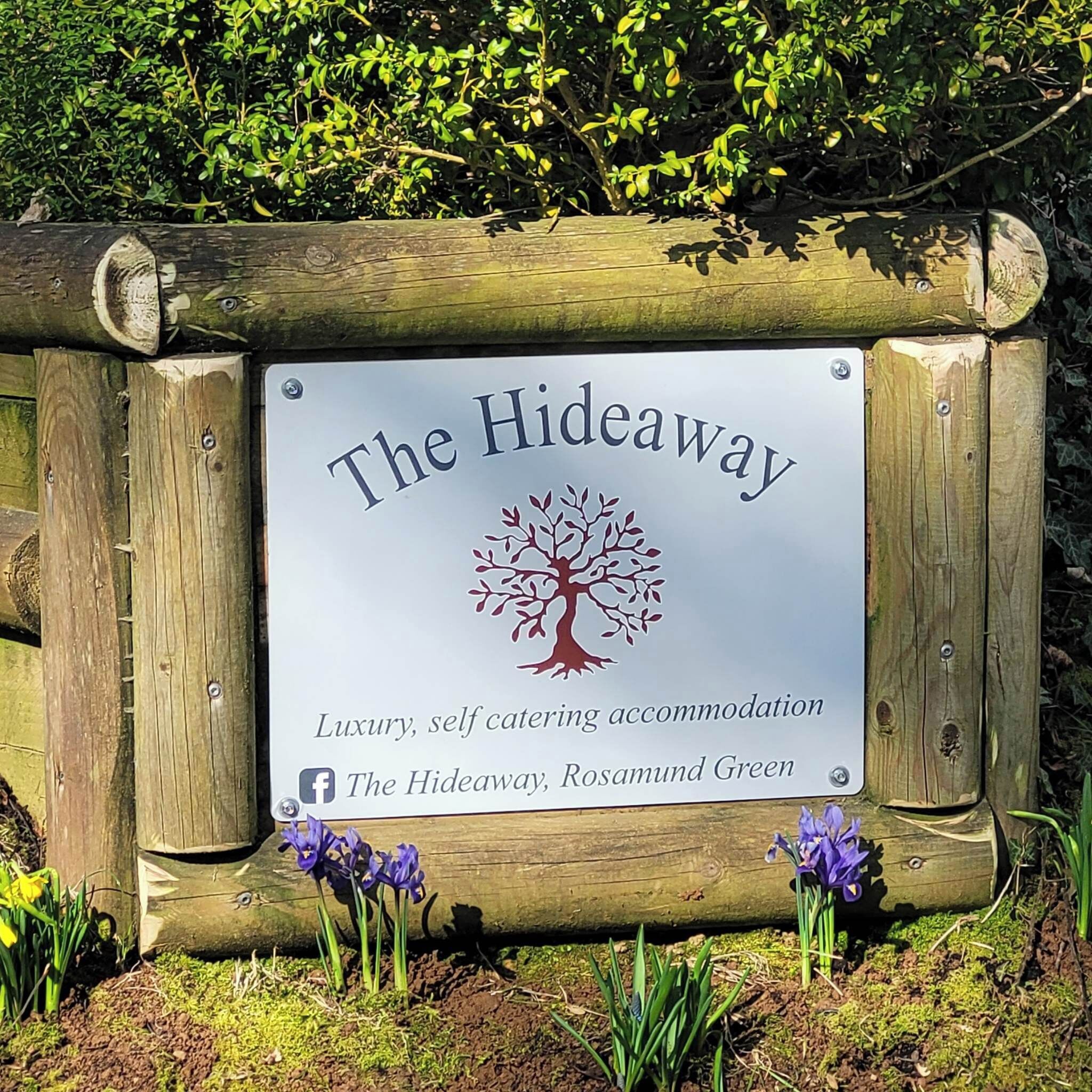 A sign for 'The Hideaway' indicating luxury, self-catering accommodation.