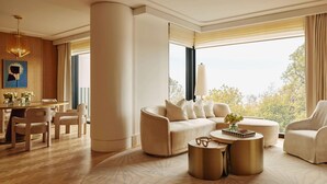 A spacious living room with a large window, a round coffee table, and a sofa. - The Emory, Maybourne (London)