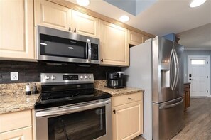 Enjoy cooking in this well-equipped kitchen with microwave, stovetop oven, and refrigerator.