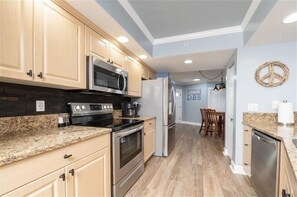 Enjoy cooking in this well-equipped kitchen with a microwave, oven, and refrigerator.