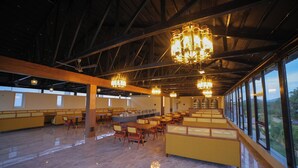A spacious indoor area with high ceilings, large windows, and multiple seating arrangements. - Lake Valley Resort and Spa, Tirupati  (Chinnagottigallu)
