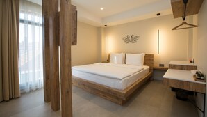 A modern bedroom with a wooden bed frame, a bedside table, a hanging light, and a view of the city through sheer curtains. - Nilus Urla (Urla)