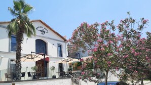 A two-story building with a sign reading "Boutique Hotel - URLA". - Nilus Urla (Urla)