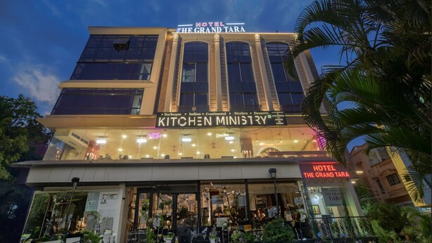 A hotel with a sign reading "Hotel The Grand Tara" and "Kitchen Ministry" below it. - HOTEL THE GRAND TARA (Indore)