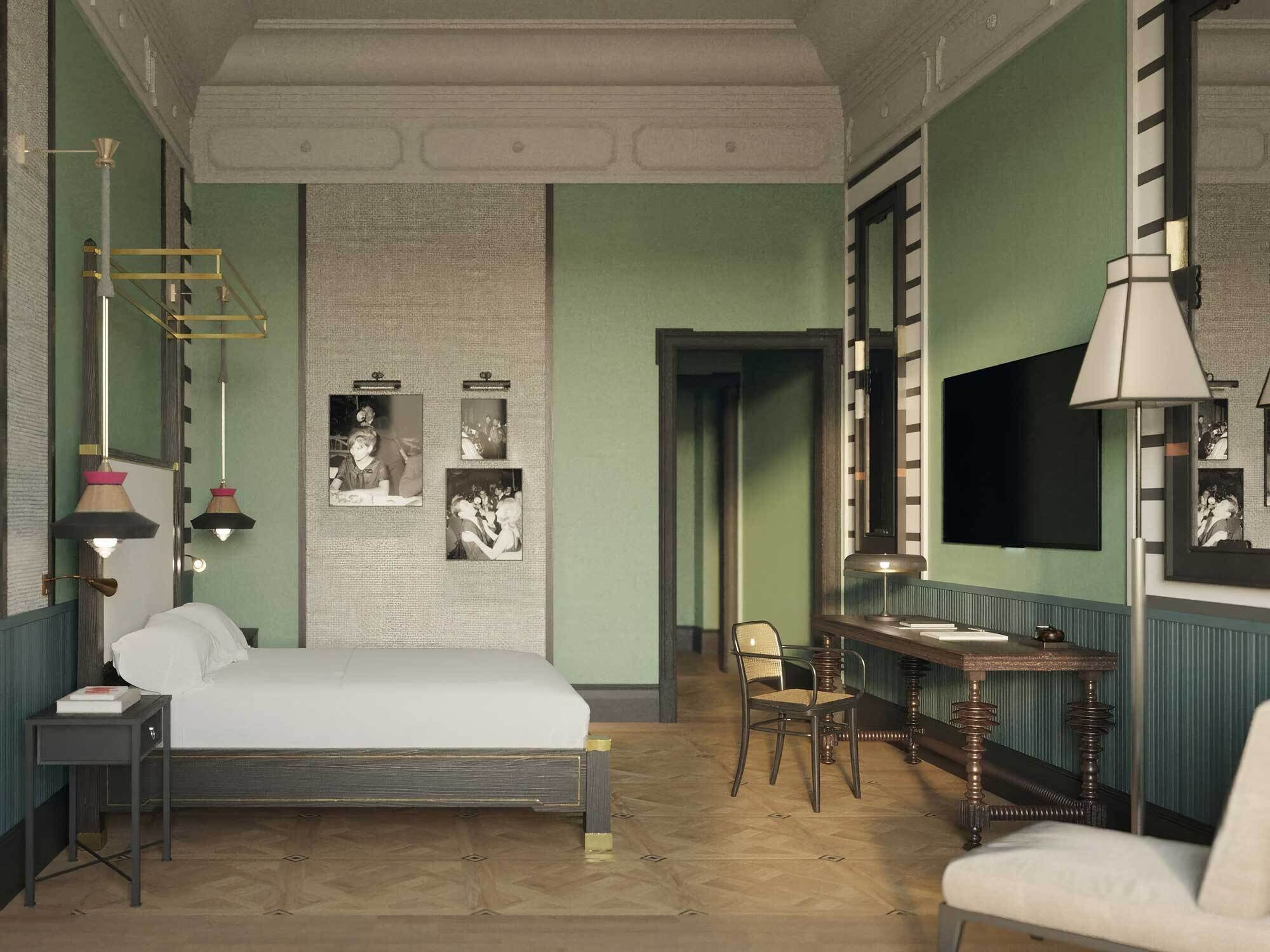 A bedroom with a bed, bedside tables, a desk, and chairs. There is a mirror, a lamp, and framed pictures on the wall.