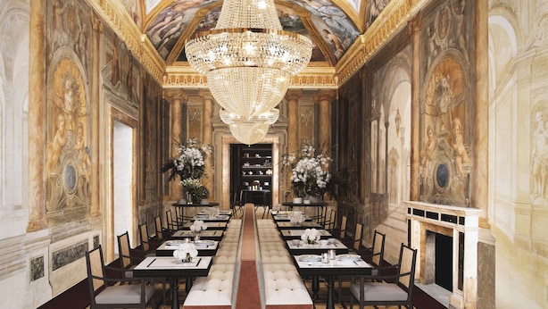 A grand hall with a long table set for a banquet, ornate chandeliers, and classical wall paintings. - Palazzo Roma - The Leading Hotels of the World (Rome)