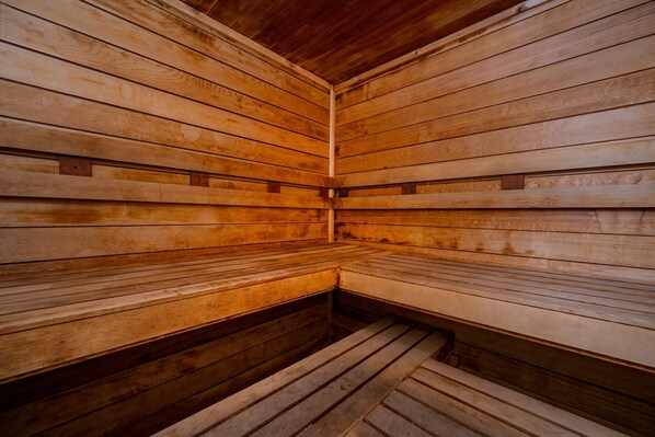 A sauna with wooden benches and walls.