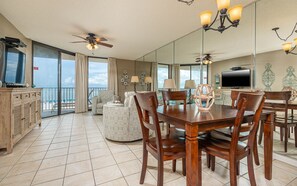 Relax in this spacious living area with a dining table, sofa, and ocean views.