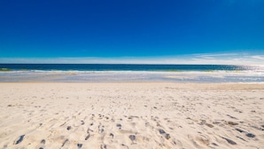 A sandy beach with footprints leading to the water. - Phoenix Vii 7508 3 Bedroom Condo (Orange Beach)