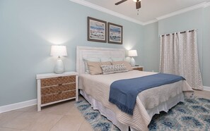 Relax in this serene bedroom with a large bed, two nightstands, and a woven basket nightstand.