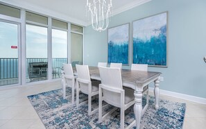 Enjoy meals in this dining area with a large table and six comfortable chairs, surrounded by ocean views.