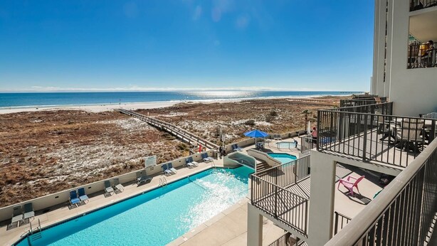 A rooftop pool with a view of the beach and ocean. - Phoenix Vi 6310 2 Bedroom Condo (Orange Beach)