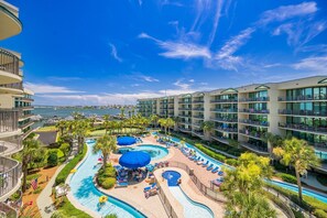 A hotel with a pool area, multiple balconies, and a view of the ocean. - Phoenix On The Bay 1428 3 Bedroom Condo (Orange Beach)