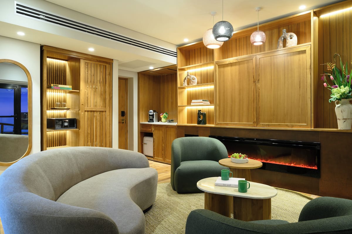 A modern living room with a fireplace, wooden cabinetry, and comfortable seating.