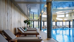 A poolside area with lounge chairs and a pool. - Canaan Hotel - Limited Edition By Fattal (Safed)