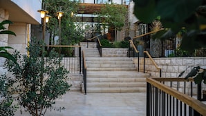A stone staircase with wooden railings leading to a building entrance. - Canaan Hotel - Limited Edition By Fattal (Safed)