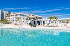 A hotel with a swimming pool, lounge chairs, and a covered area. - 🌊 Beachfront Bliss on the Fort Morgan Peninsula – Chic Condo with Panoramic Gulf Views (Gulf Shores)
