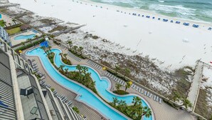 A resort with a pool area, beach, and ocean view. - Phoenix West 1204 3 Bedroom Condo (Orange Beach)