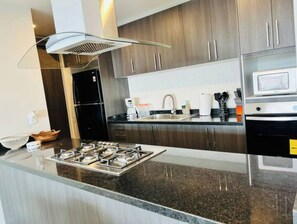 Fridge, oven, coffee/tea maker, cookware/dishes/utensils