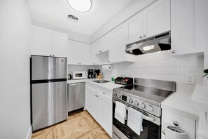 Enjoy cooking in this well-equipped kitchen with a refrigerator, microwave, and oven, plus a convenient coffee station.