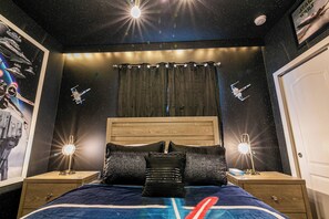 Experience a celestial retreat with a starry night theme, featuring a comfortable bed and space-inspired decor.