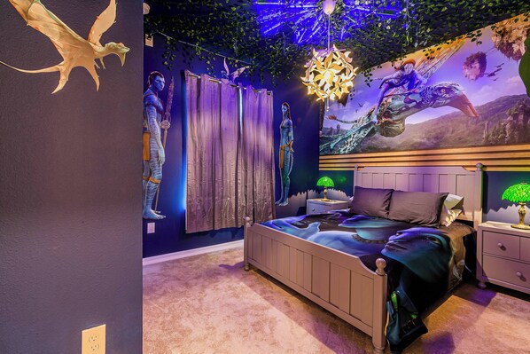 A bedroom with a bed, nightstands, and a mural.