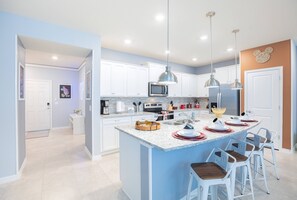 Enjoy cooking and socializing in this kitchen with a large island and stainless steel appliances.