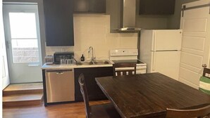 A compact kitchen with a dining area, a dishwasher, a stove, and a refrigerator. - Walkout basement and easy access to I-70 and DIA (Denver)