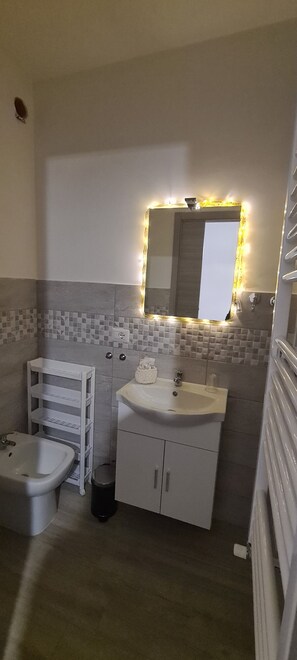 Eenvoudige resortwoning | Badkamer | Een douche, een regendouche, gratis toiletartikelen, een haardroger