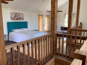 Relax in a spacious room with a large bed and a separate area for work.