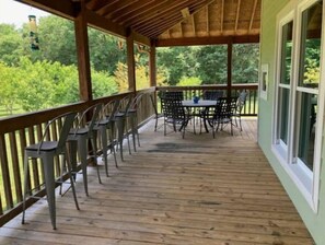 Enjoy dining or socializing on the deck with views of the surrounding greenery.