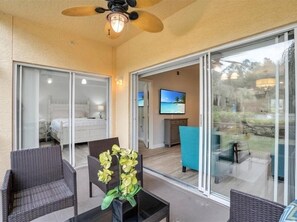 Relax in this serene space with a comfortable bed, TV, and outdoor access.