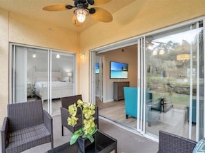 Relax in this serene space with a comfortable bed, TV, and outdoor access.