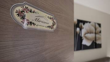 A wooden door with a nameplate that reads "Miriam."