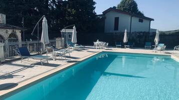 Seasonal outdoor pool, open 9:00 AM to 7:00 PM, pool umbrellas