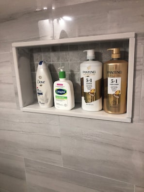 A bathroom shelf with Dove, Cetaphil, and Pantene products. - Bedroom with private full bathroom, linen and towels are provided. (Chicago)