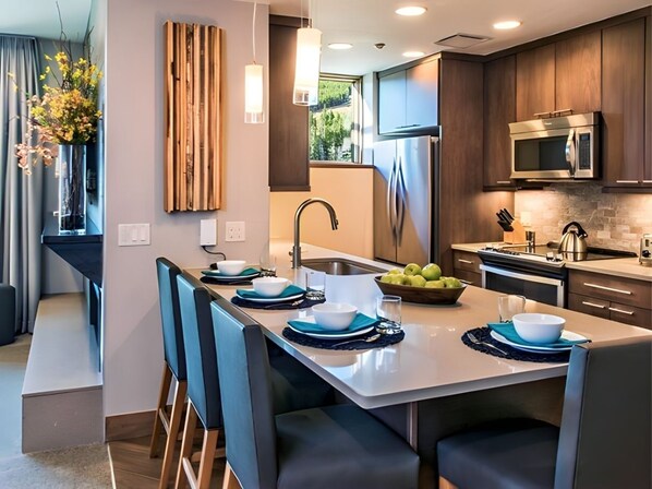 Enjoy meals in the kitchen with a central island, microwave, and dining area with comfortable seating.
