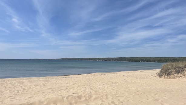 A sandy beach with a clear sky and calm water. - Beach/Ski Home in Harbor Springs (Harbor Springs)