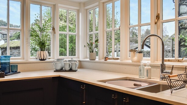 A kitchen with a large window, a sink, and a countertop. - 2 bedroom accommodation in Ambleside (Ambleside)