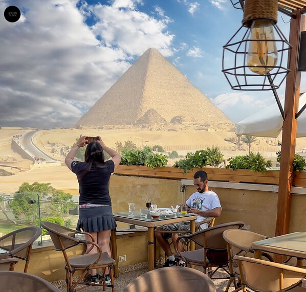 A dining area with a view of a pyramid.