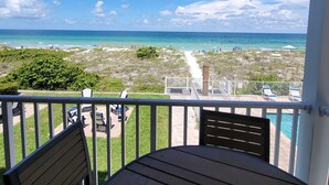 A balcony with a view of the ocean, a pool, and beach chairs. - NEW! 2/2, IRB-Beach/Pool View, Sleeps 6, unit F (Indian Rocks Beach)