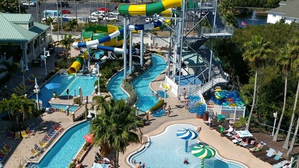 A water park with multiple pools, slides, and a beach area with sun loungers. - NEW! 2/2, IRB-Beach/Pool View, Sleeps 6, unit F (Indian Rocks Beach)