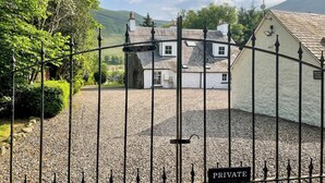 A private property with a gravel driveway and a metal gate. - The Old Manse - UKC6854 (Glenclova, near Kirriemuir)