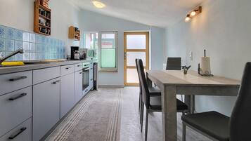 Fridge, stovetop, dishwasher, coffee/tea maker