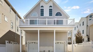 A two-story house with a balcony, two garages, and a covered driveway. - 4305 Park Road, Sea Isle City (Sea Isle City)