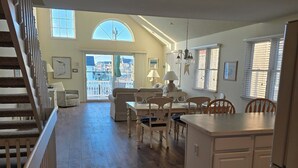 A spacious living area with a dining table, chairs, and a kitchen area with a refrigerator. - 4305 Park Road, Sea Isle City (Sea Isle City)